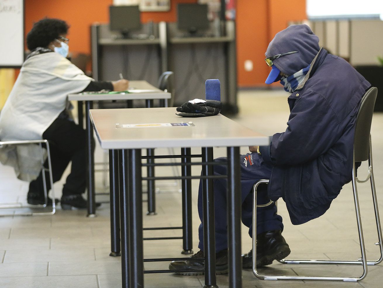 Clients fill out paperwork at the Department of
Workforce Services in Salt Lake City on Friday, Dec. 18, 2020.