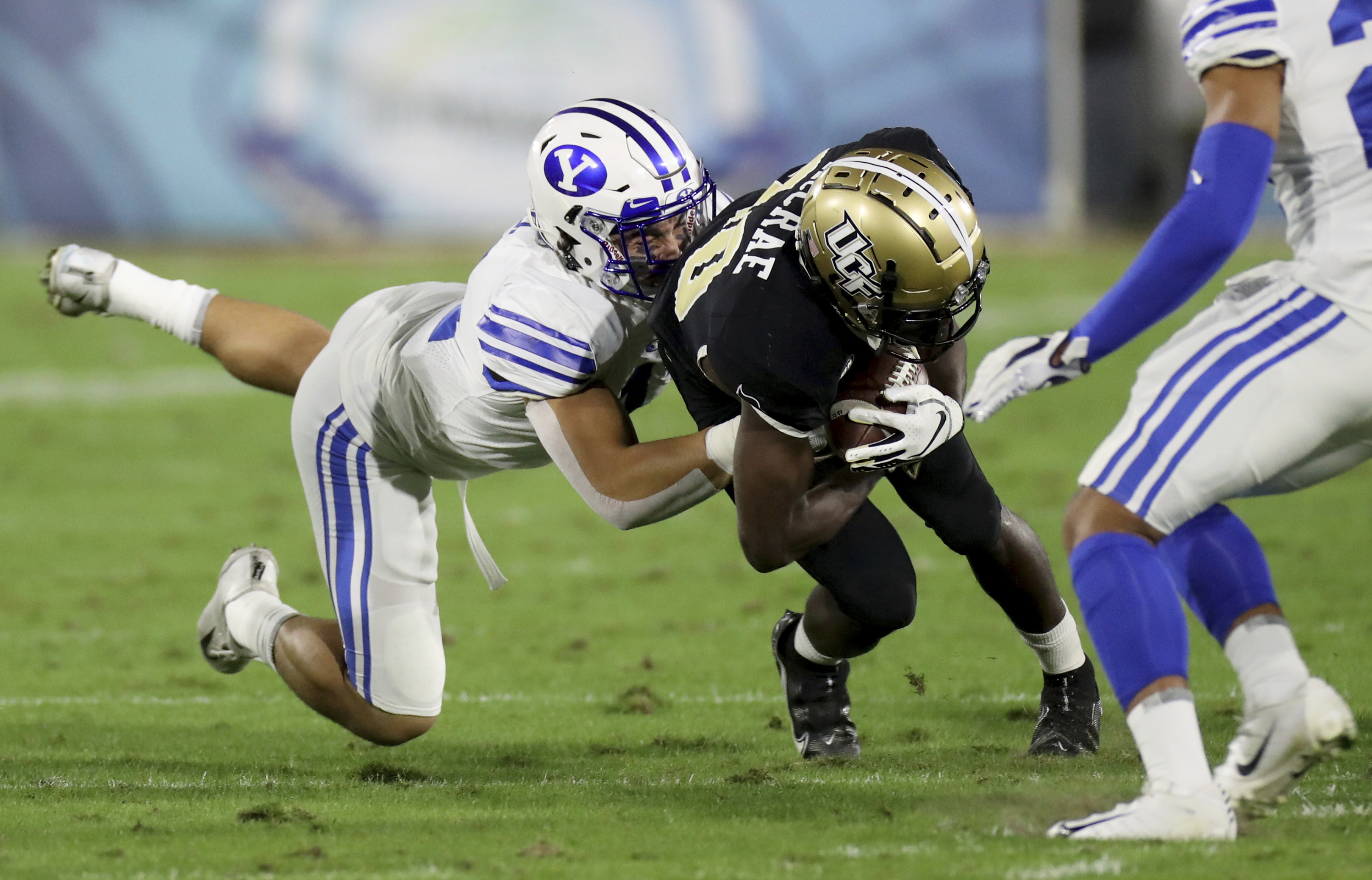 Central Florida's Greg McCrae is tackled after making a reception in the first quarter against BYU in the Boca Raton Bowl NCAA college football game Tuesday, Dec. 22, 2020, in Boca Raton, Fla.