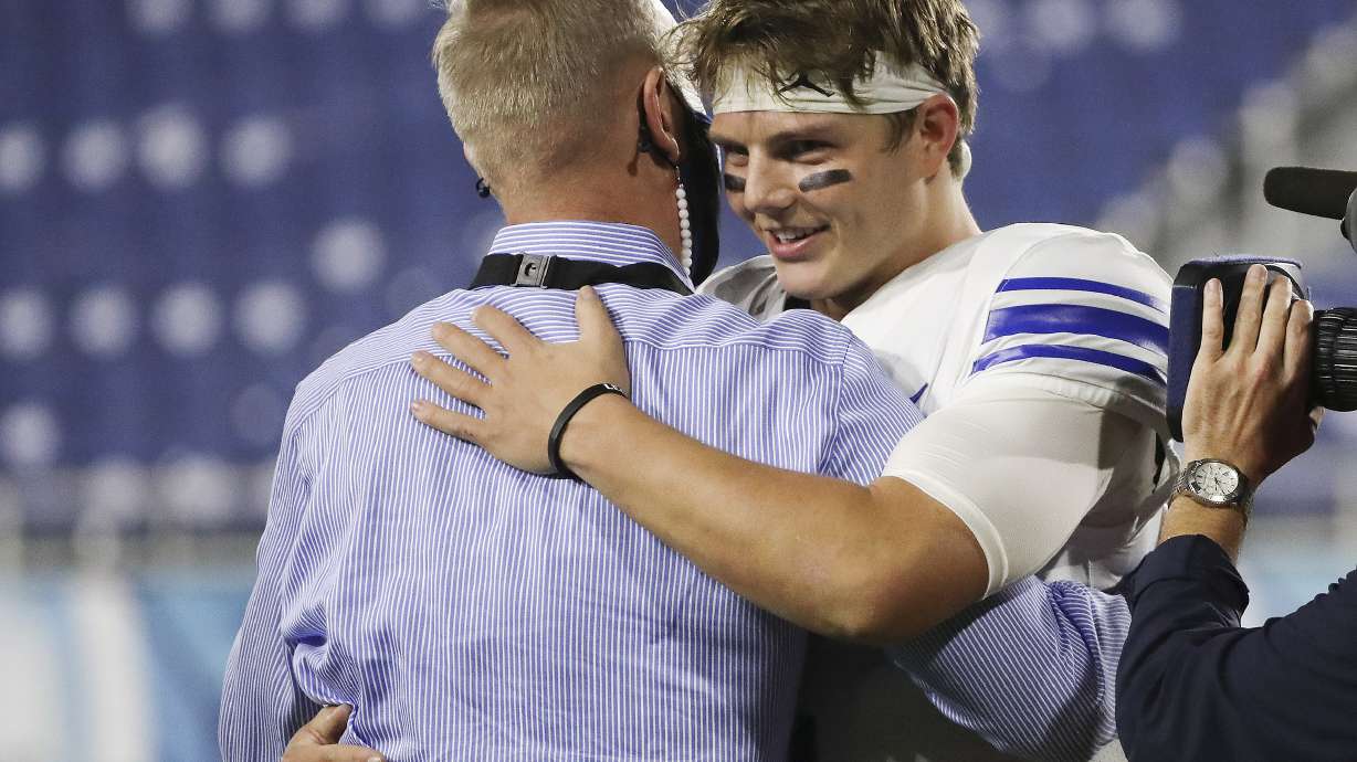 Brigham Young Cougars quarterback Zach Wilson (1) celebrates the win over the UCF Knights with athletic director Tom Holmoe after the Boca Raton Bowl in Boca Raton, Fla., on Tuesday, Dec. 22, 2020. BYU won 49-23.