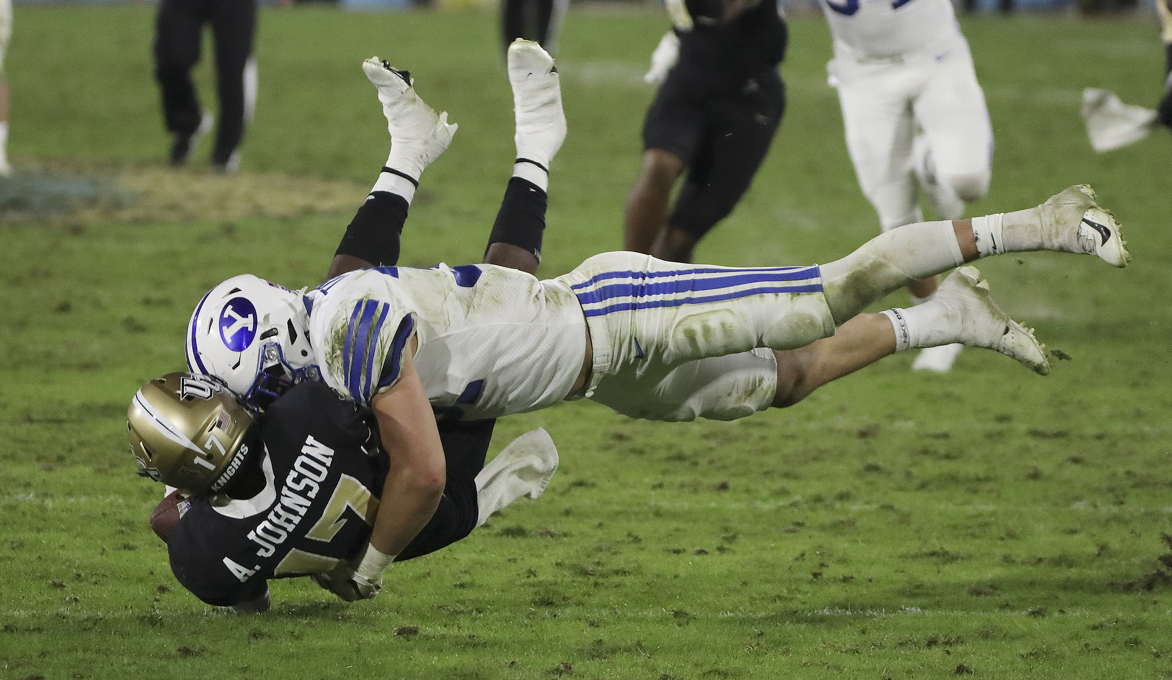 Brigham Young Cougars linebacker Max Tooley (31) levels UCF Knights punt returner Amari Johnson (17) during the Boca Raton Bowl in Boca Raton, Fla., on Tuesday, Dec. 22, 2020.