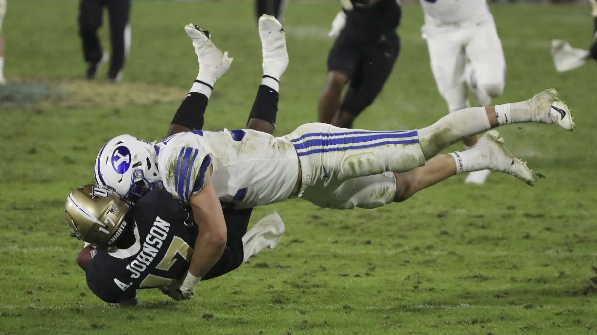 Brigham Young Cougars linebacker Max Tooley (31) levels UCF Knights punt returner Amari Johnson (17) during the Boca Raton Bowl in Boca Raton, Fla., on Tuesday, Dec. 22, 2020.