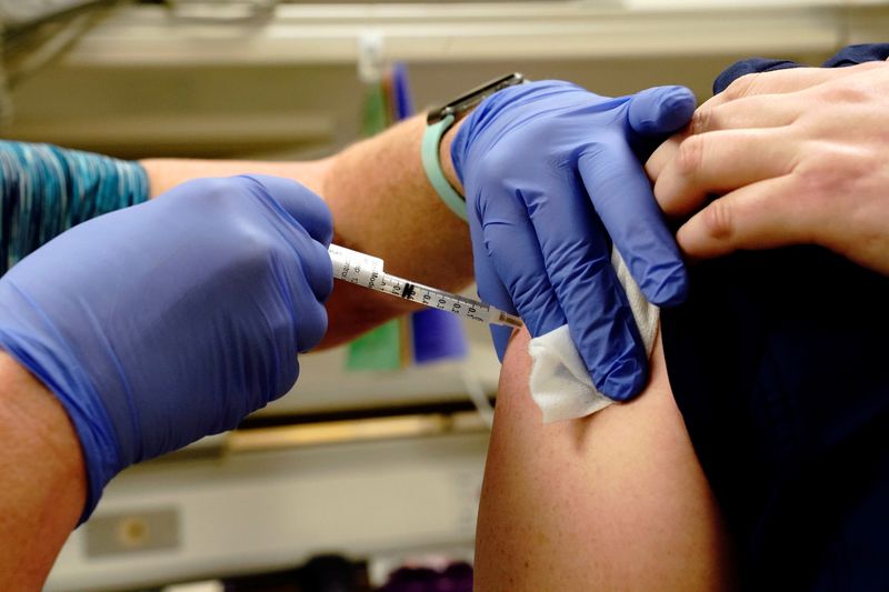 FILE PHOTO: A healthcare worker receives a dose of the Moderna coronavirus disease (COVID-19) vaccine at Rady Children's Hospital in San Diego, California, U.S., December 22, 2020.  REUTERS/Bing Guan
