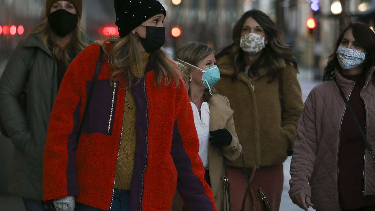 Erin Fox, left, Karen Hollingsworth, Daphenie Baugh, Laura Tenney and Cindy Gilbert wear masks as they walk to dinner in Salt Lake City on Thursday, Nov. 12, 2020.