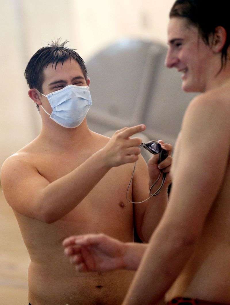 Lance Gillespie jokes around with teammate Jonathan
Page during practice in Layton on Friday, Dec. 4, 2020. Gillespie
is captain of the Davis High School varsity swim team.