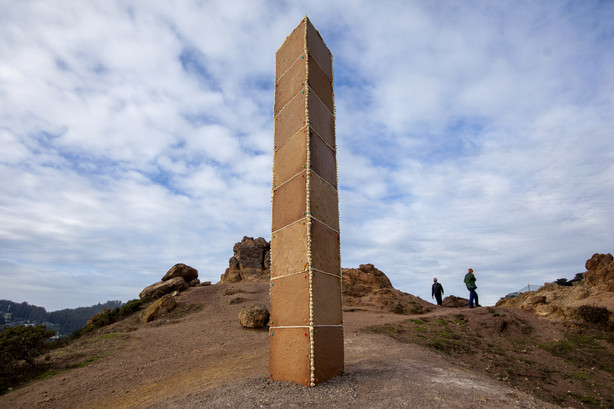 A gingerbread monolith stands on Christmas Day, Dec. 25, 2020, on a bluff in Corona Heights Park overlooking San Francisco. A nearly 7-foot-tall monolith made of gingerbread mysteriously appeared on the San Francisco hilltop on Christmas Day and collapsed the next day. The three-sided tower, held together by icing and decorated with a few gumdrops, delighted the city when word spread about its existence.