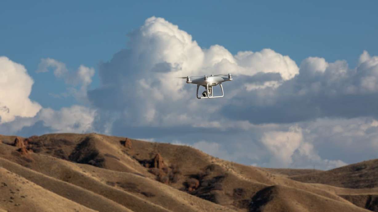 Weber State University geography student Timber
Erickson and professor Bryan Dorsey use a drone to explore
locations for a proposed wildlife crossing bridge over I-84 in
Summit County on Tuesday, Nov. 3, 2020. The research is part of a
senior project by Erickson.