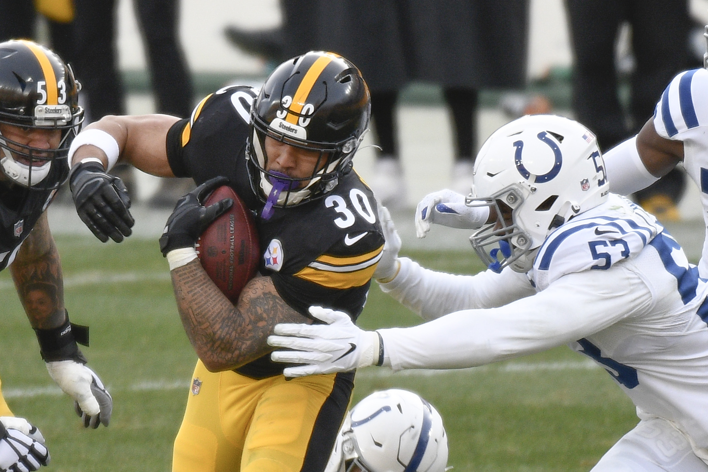 Pittsburgh Steelers running back James Conner (30) runs away from Indianapolis Colts defensive end Kemoko Turay (57) during the second half of an NFL football game, Sunday, Dec. 27, 2020, in Pittsburgh.
