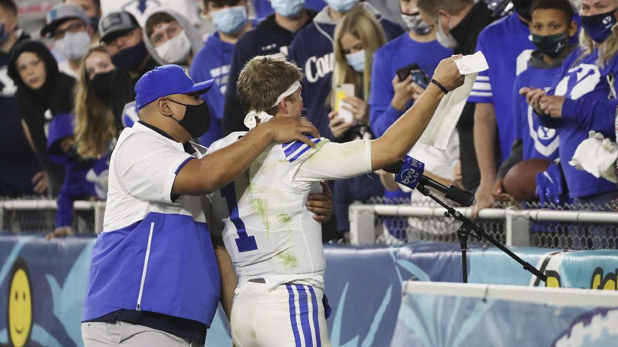 Brigham Young Cougars head coach Kalani Sitake and Brigham Young Cougars quarterback Zach Wilson (1) celebrate the win over the UCF Knights with fans during the Boca Raton Bowl in Boca Raton, Fla., on Tuesday, Dec. 22, 2020. BYU won 49-23.
