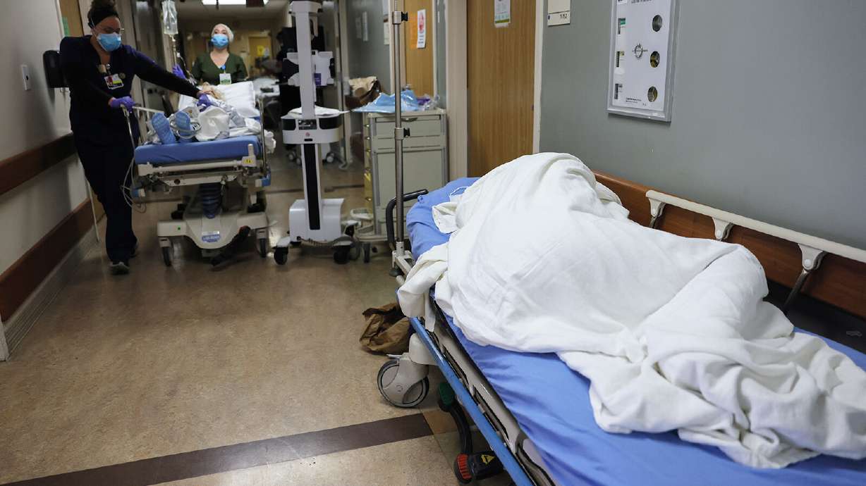 A patient lies on a stretcher in the hallway of the overloaded Emergency Room at Providence St. Mary Medical Center amid a surge in COVID-19 patients in Southern California on December 23, 2020 in Apple Valley, California.