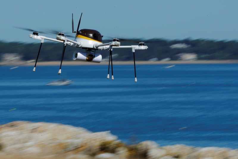 FILE PHOTO: A drone, made by CyPhy Works, carries a UPS package on Children's Island off the coast of Beverly, Massachusetts, U.S. September 22, 2016, during UPS's demonstration of a drone making a commercial delivery of a package to a remote or difficult-to-access location. REUTERS/Brian Snyder/File Photo