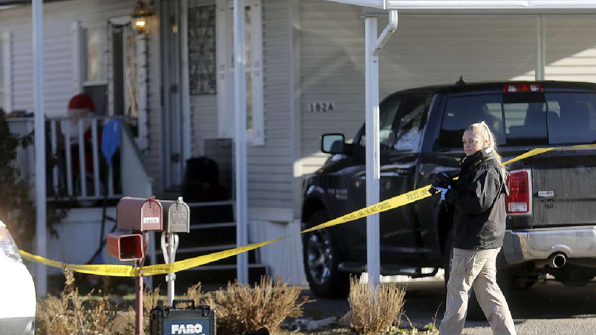 A Weber Metro CSI unit photographer works at the scene of a fatal shooting that occurred early Christmas morning in Riverdale, Weber County, on Friday, Dec. 25, 2020.