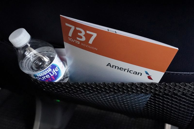 FILE PHOTO: A seat back card and a bottle of water are pictured on a media flight aboard a Boeing 737 Max airplane from Dallas Fort Worth Airport to Tulsa, Oklahoma in Dallas, Texas, U.S., December 2, 2020. REUTERS/Carlo Allegri/File Photo