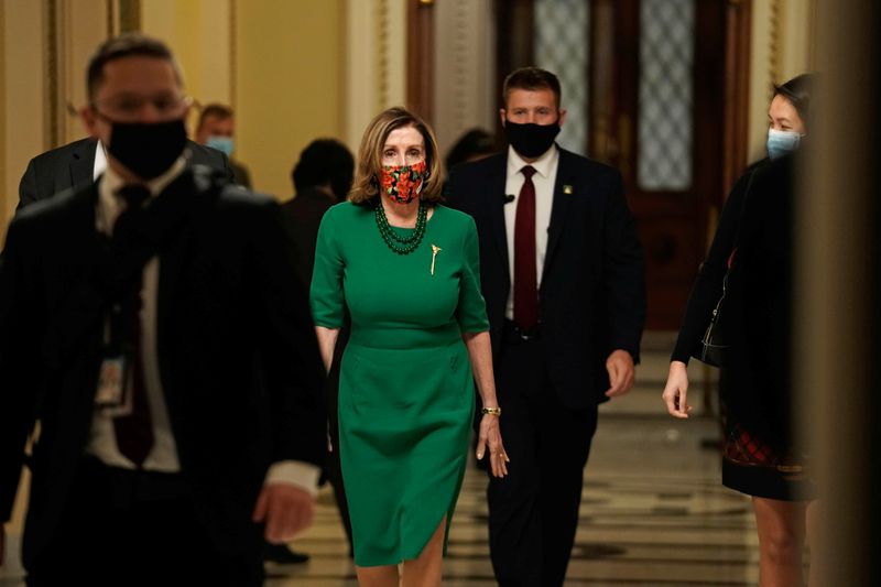 FILE PHOTO: Speaker of the House Nancy Pelosi (D-CA), walks from the Senate floor as both chambers of Congress are aimed to pass the coronavirus disease (COVID-19) package in a marathon session on Capitol Hill Washington, D.C., U.S., December 21, 2020. REUTERS/Ken Cedeno