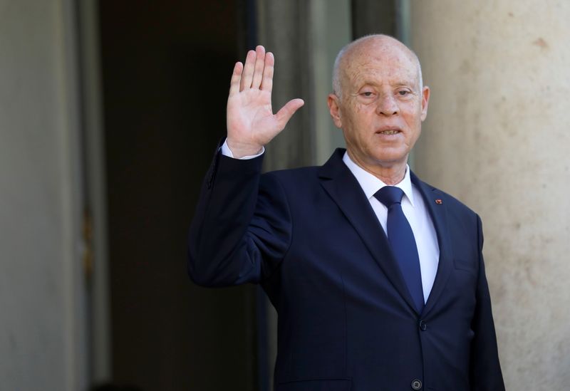 FILE PHOTO: Tunisia's President Kais Saied waves as he is welcomed by French President Emmanuel Macron (not pictured) before a meeting at the Elysee Palace in Paris, France, June 22, 2020. REUTERS/Charles Platiau