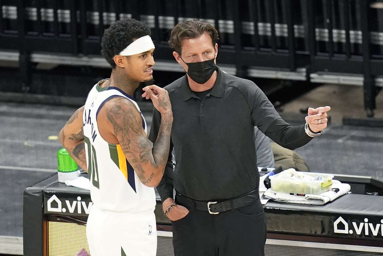 Utah Jazz head coach Quin Snyder speaks with Jordan Clarkson (00) during the second half of an NBA preseason basketball game against the Phoenix Suns Saturday, Dec. 12, 2020, in Salt Lake City. (AP Photo/Rick Bowmer)