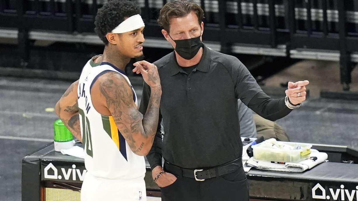 Utah Jazz head coach Quin Snyder speaks with Jordan Clarkson (00) during the second half of an NBA preseason basketball game against the Phoenix Suns Saturday, Dec. 12, 2020, in Salt Lake City. (AP Photo/Rick Bowmer)
