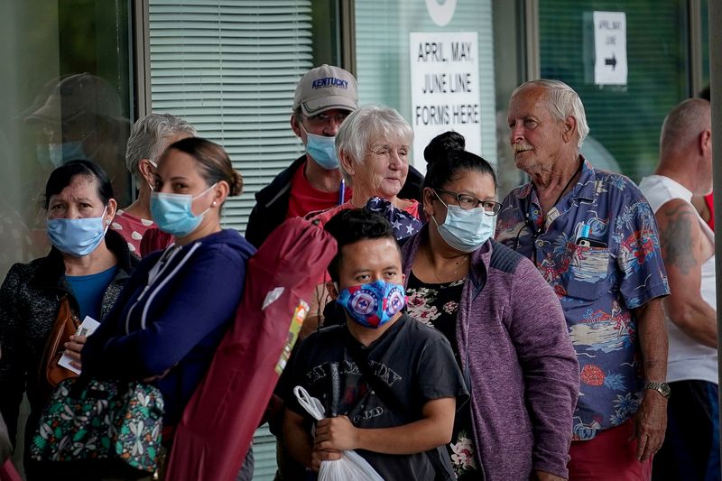 FILE PHOTO: People line up outside a Kentucky Career Center hoping to find assistance with their unemployment claim in Frankfort, Kentucky, U.S. June 18, 2020. REUTERS/Bryan Woolston