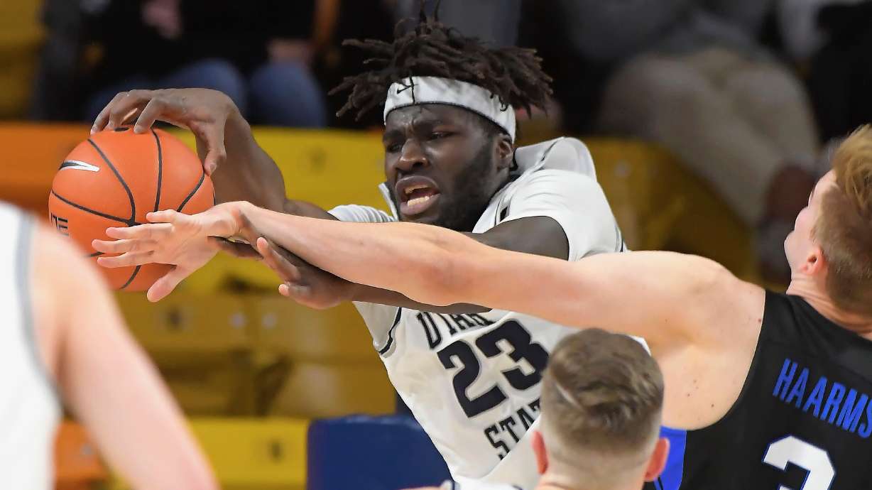 Utah State center Neemias Queta (23) and BYU forward Matt Haarms (3) go for a rebound during the second half of an NCAA college basketball game Saturday, Dec. 5, 2020, in Logan, Utah. (Eli Lucero/The Herald Journal via AP, Pool)