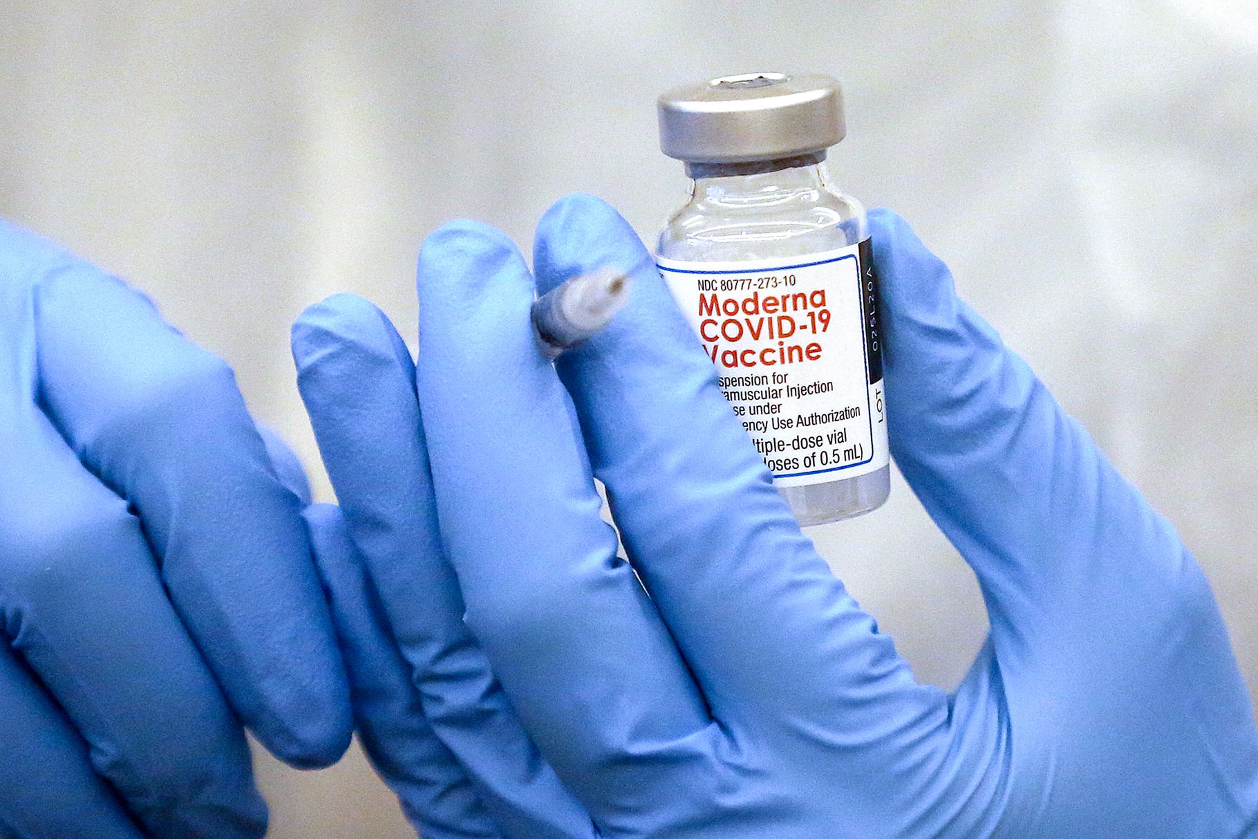 Shixian Wang, a pharmacist with Red Rock Pharmacy, fills a syringe with the Moderna COVID-19 vaccine at The Ridge Foothill senior living facility in Salt Lake City on Tuesday, Dec. 29, 2020.