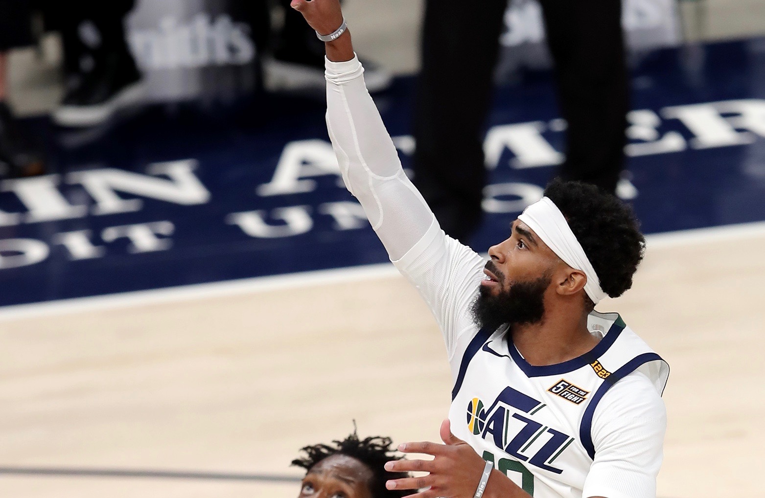 Utah Jazz guard Mike Conley (10) pushes up a shot over LA Clippers guard Patrick Beverley (21) as the Utah Jazz and LA Clippers play in an NBA basketball game at Vivint Smart Home Arena in Salt Lake City on Friday, Jan. 1, 2021.