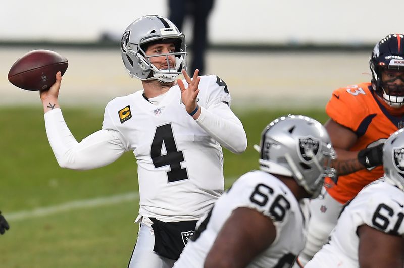 Jan 3, 2021; Denver, Colorado, USA; Las Vegas Raiders quarterback Derek Carr (4) throws a pass against the Denver Broncos during the second quarter at Empower Field at Mile High. Mandatory Credit: Ron Chenoy-USA TODAY Sports