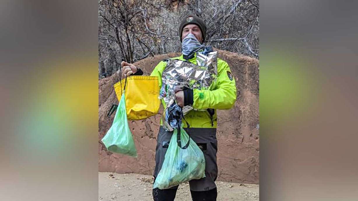 "Ranger John" holding the 14 pounds of trash he found while patrolling The Narrows.