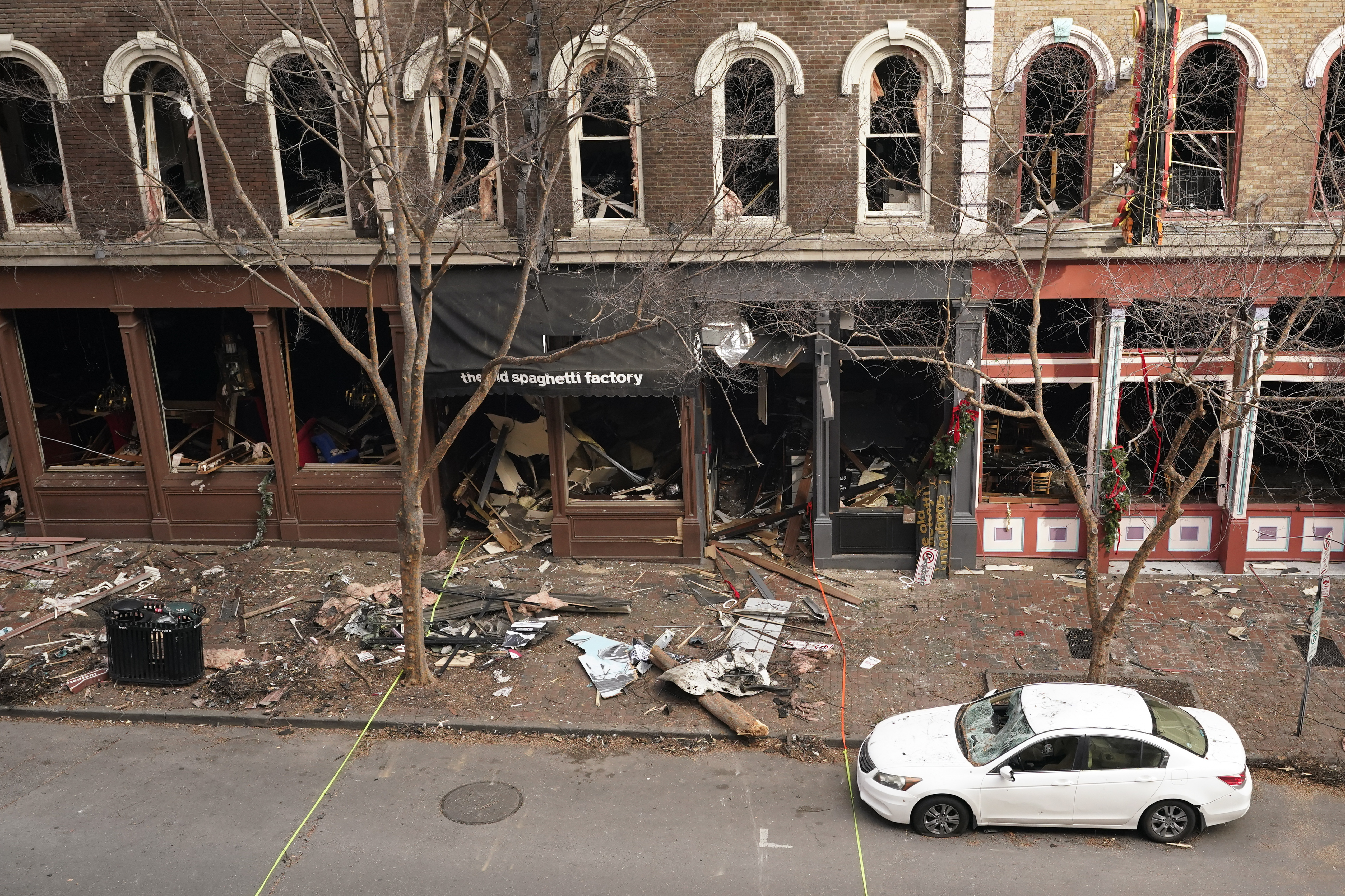 Debris remains on the sidewalk in front of buildings damaged in a Christmas Day explosion in Nashville, Tenn. 