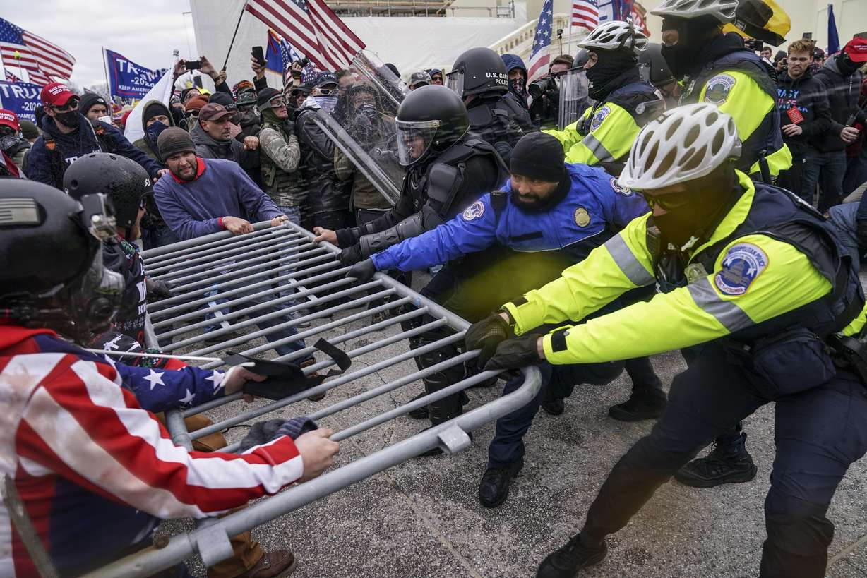 Trump supporters try to break through a police barrier, Wednesday, Jan. 6, 2021, at the Capitol in Washington. As Congress prepares to affirm President-elect Joe Biden's victory, thousands of people have gathered to show their support for President Donald Trump and his claims of election fraud.
