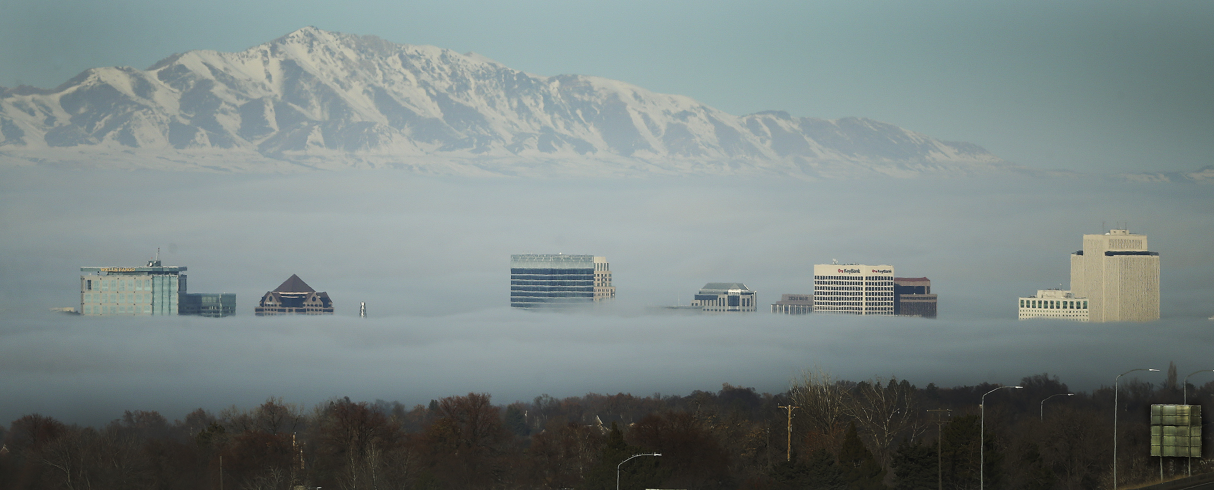 Downtown buildings poke through the inversion in Salt Lake City on Saturday, Dec. 7, 2019.