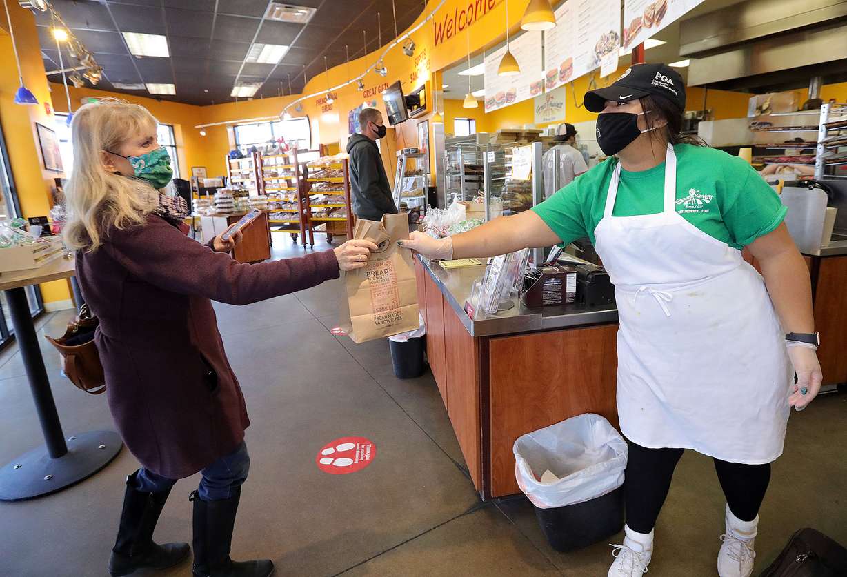 Laurie Bray picks up her order from Raeleigh Sasser at Great Harvest Bread Co. in Taylorsville on Wednesday, Jan. 6, 2021.