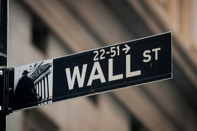FILE PHOTO: A Wall St. sign is seen near the New York Stock Exchange (NYSE) in the financial district in New York, U.S., November 24, 2020. REUTERS/Brendan McDermid