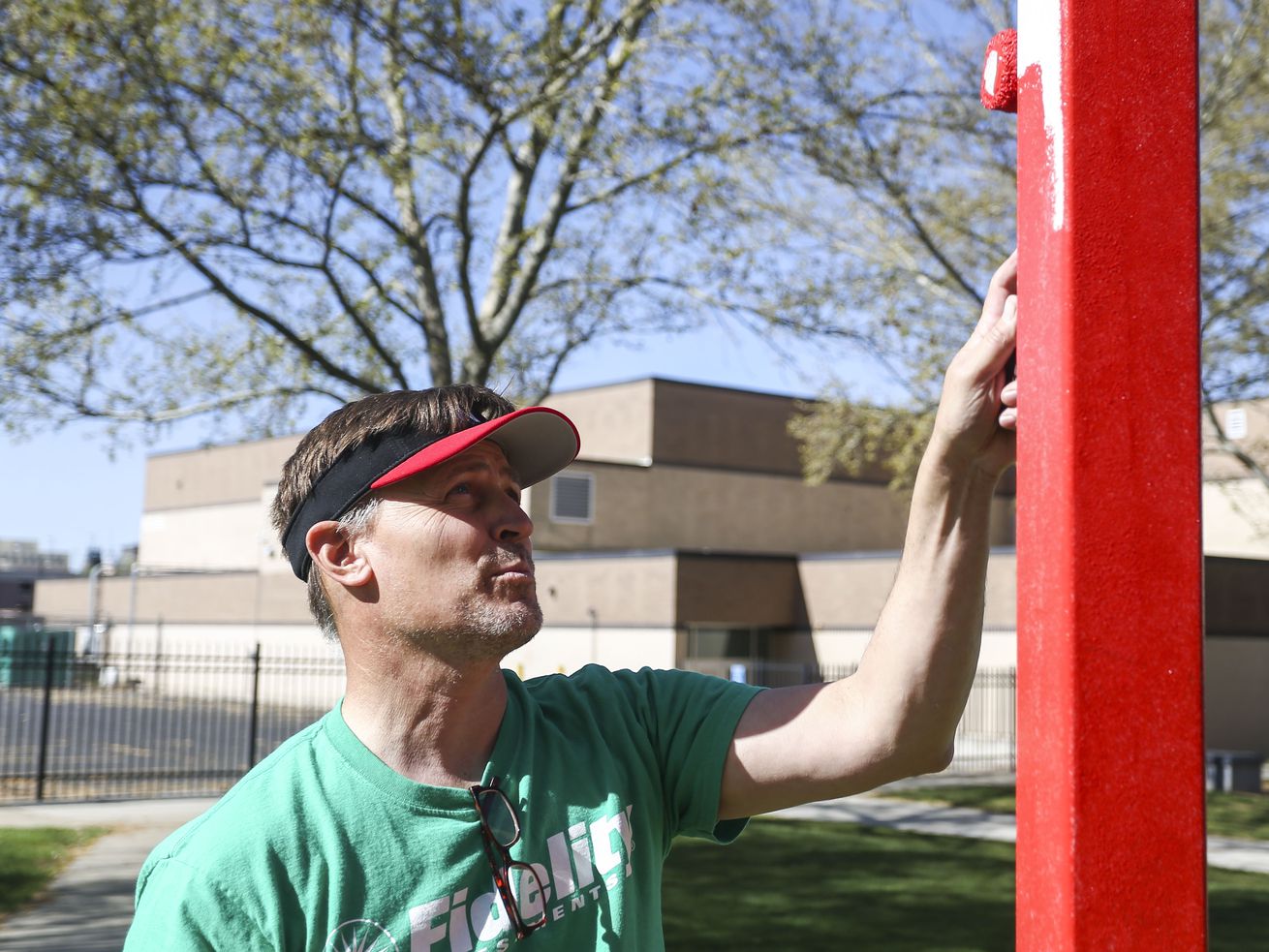 Then-West High School Principal Ford White paints
alongside volunteers from Fidelity Investments at the Salt Lake
City school in this April 27, 2019, file photo.