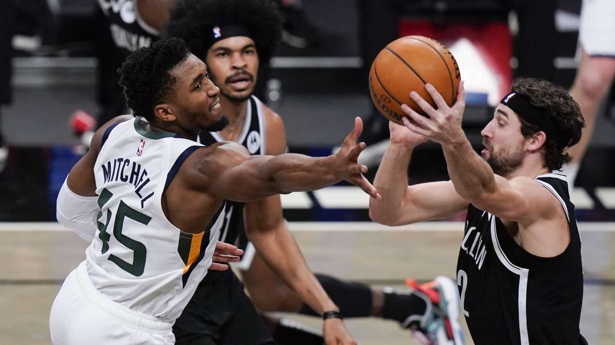 Utah Jazz's Donovan Mitchell (45) fights for control of the ball with Brooklyn Nets' Joe Harris (12) during the second half of an NBA basketball game Tuesday, Jan. 5, 2021, in New York. (AP Photo/Frank Franklin II)