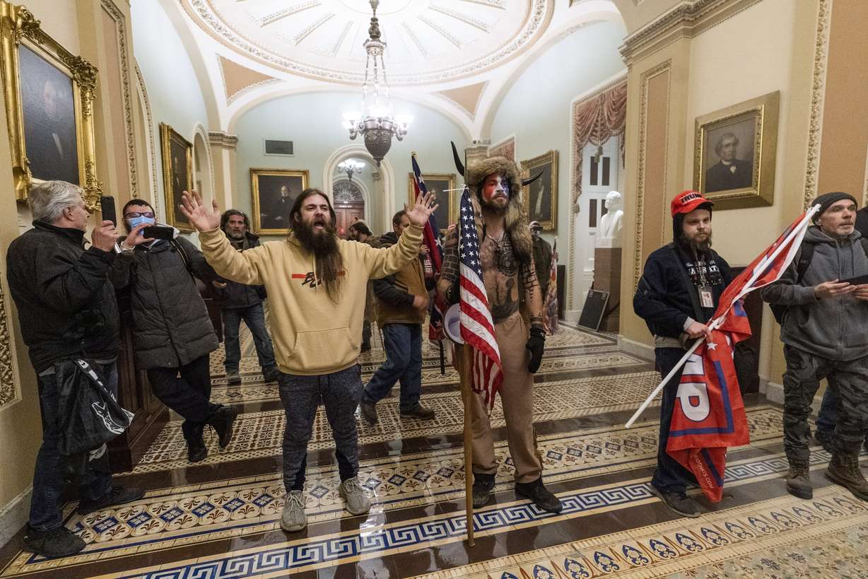 FILE - In this Wednesday, Jan. 6, 2021 file photo, supporters of President Donald Trump are confronted by U.S. Capitol Police officers outside the Senate Chamber inside the Capitol in Washington.