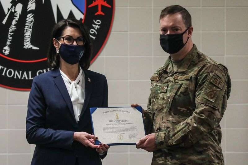 Utah Lt. Gov. Deidre Henderson, left, presents the Utah
Cross to Tech. Sgt. Urian Marshall, right, at the Roland R. Wright
Air National Guard Base in Salt Lake City on Saturday, Jan. 9,
2020.