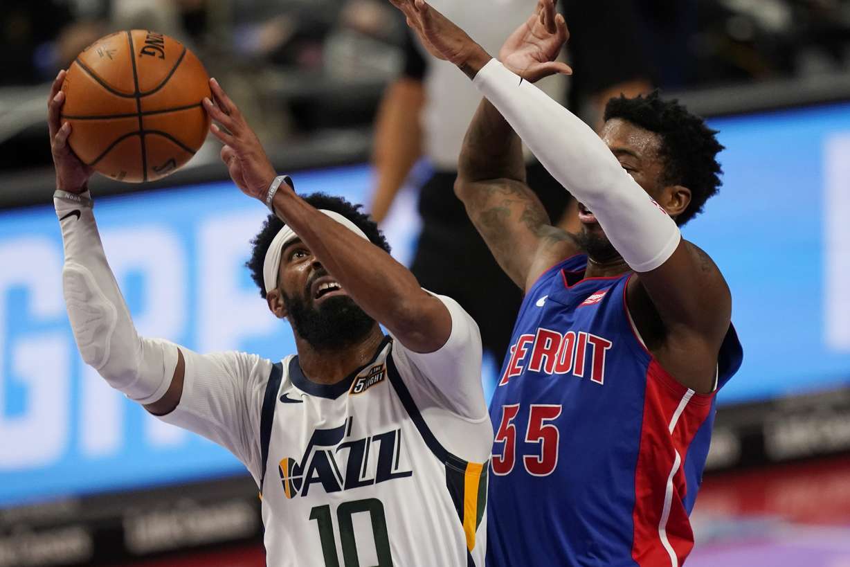 Utah Jazz guard Mike Conley (10) is defended by Detroit Pistons guard Delon Wright (55) during the first half of an NBA basketball game, Sunday, Jan. 10, 2021, in Detroit. (AP Photo/Carlos Osorio)