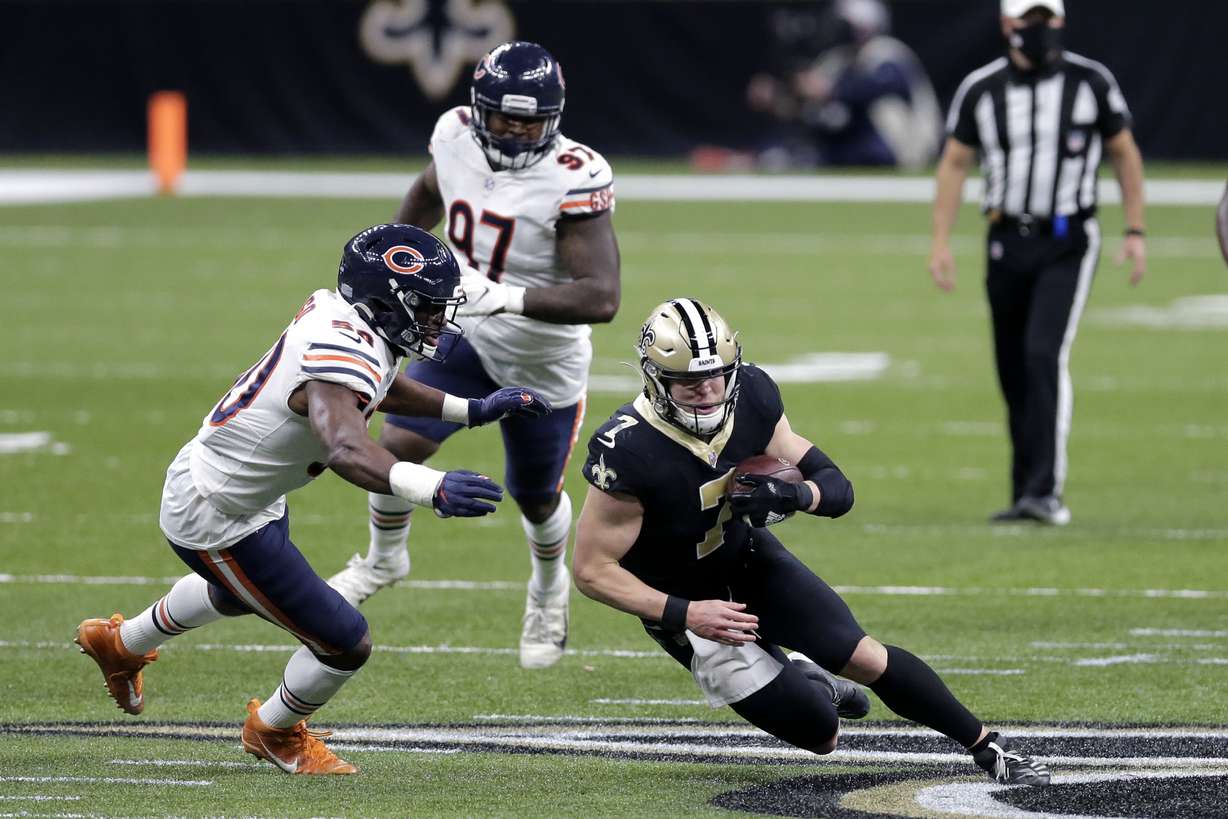 New Orleans Saints quarterback Taysom Hill (7) is pursued by Chicago Bears outside linebacker Barkevious Mingo (50) after catching a pass in the second half of an NFL wild-card playoff football game in New Orleans, Sunday, Jan. 10, 2021.