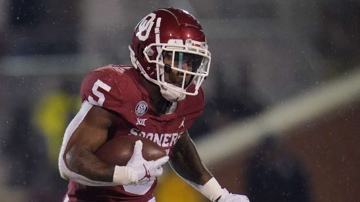 Oklahoma running back T.J. Pledger (5) carries during an NCAA college football game against Oklahoma State in Norman, Okla., Saturday, Nov. 21, 2020. (AP Photo/Sue Ogrocki)