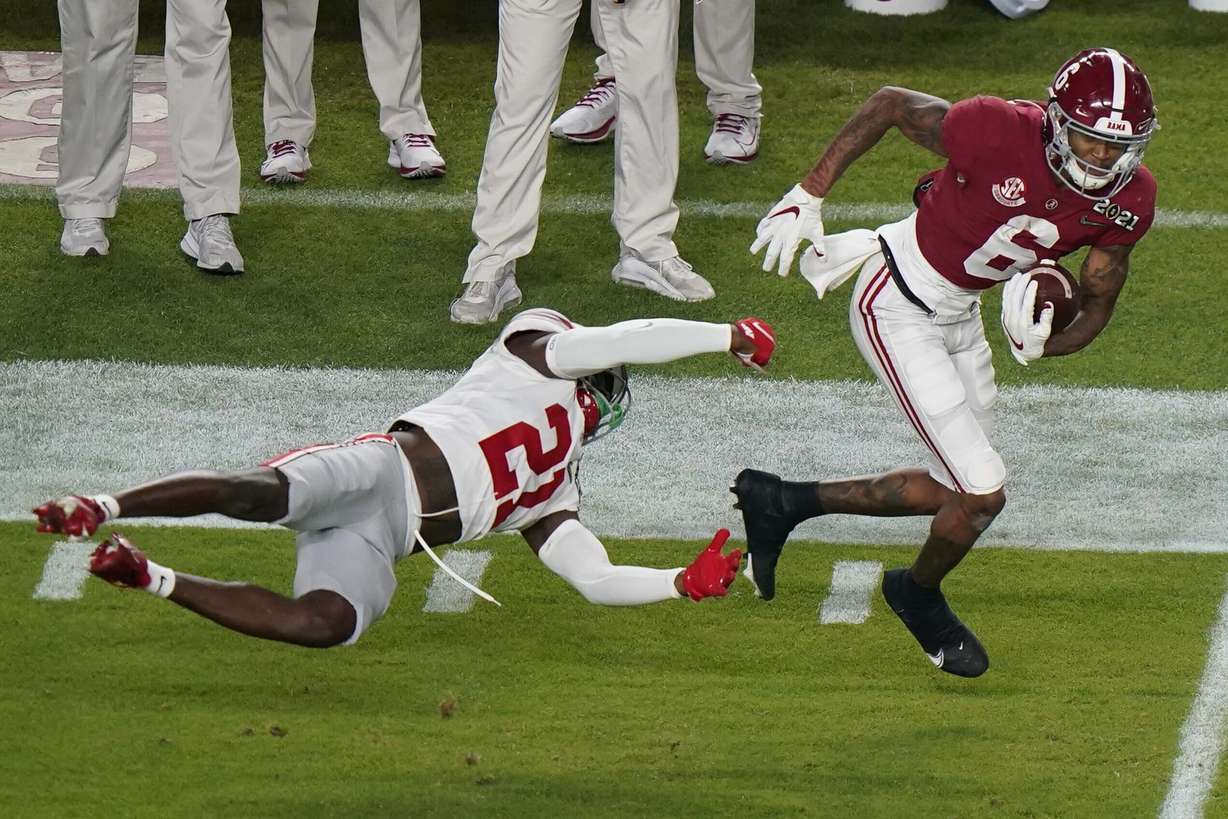 Alabama wide receiver DeVonta Smith runs past Ohio State cornerback Marcus Williamson during the first half of an NCAA College Football Playoff national championship game, Monday, Jan. 11, 2021, in Miami Gardens, Fla.