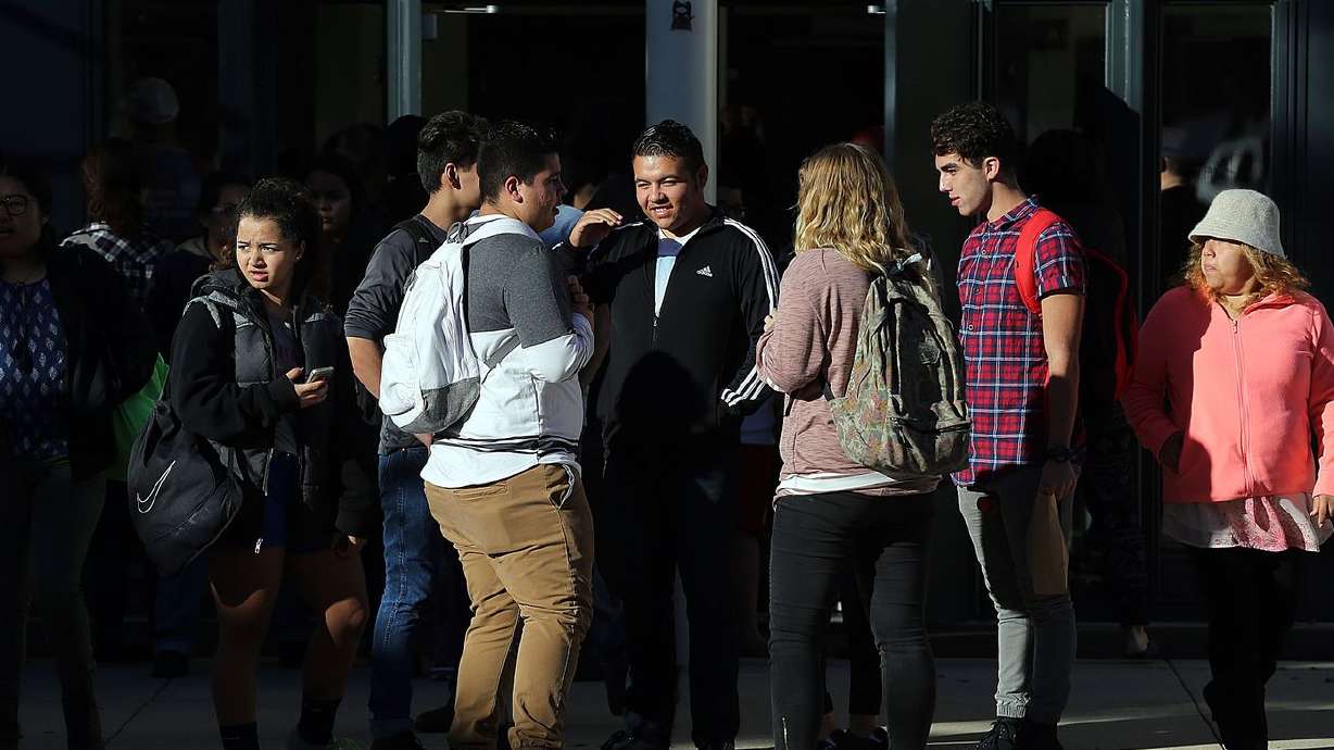 Parents and students gather outside Mountain View High
School in Orem on Tuesday, Nov. 15, 2016, after five students were
stabbed in an attack by a 16-year-old student.