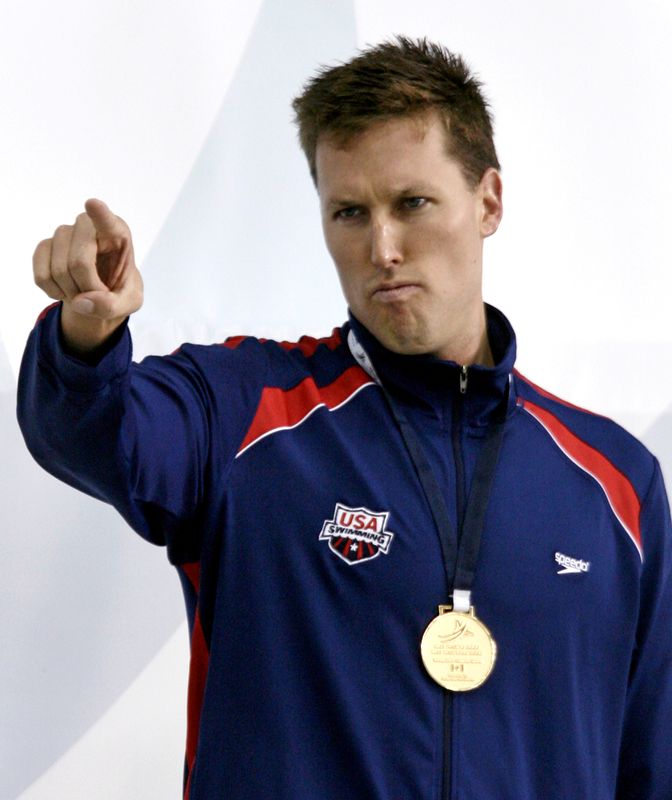 FILE PHOTO: Klete Keller of the U.S. stands with his gold medal after the men's 200m freestyle event at the Pan Pacific 2006 swimming championships in Victoria, August 17, 2006.   REUTERS/Jason Reed  (CANADA)/File Photo
