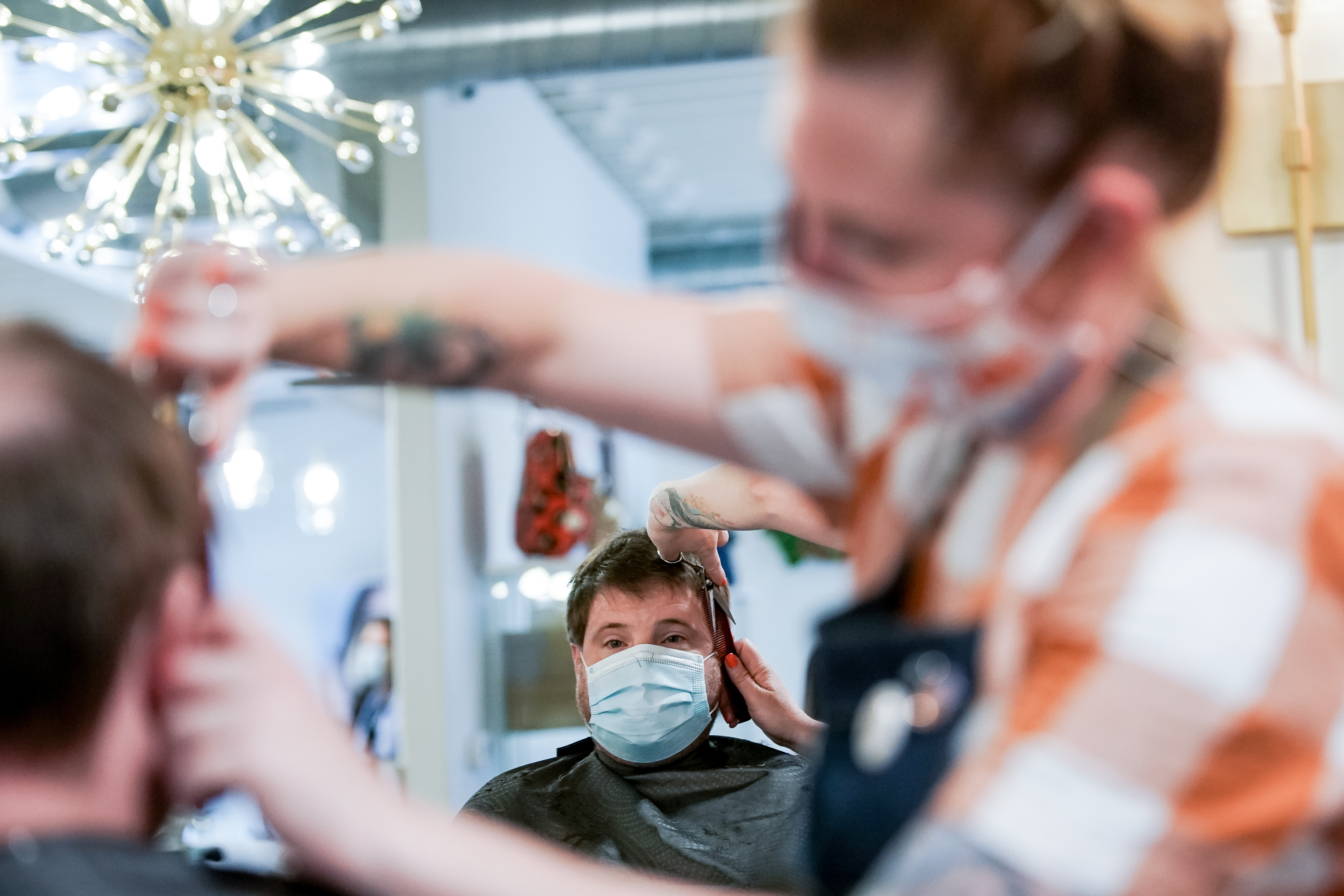 Stylist Michelle Knodel gives her brother Dan Knodel a haircut at Nailed! in Millcreek on Thursday, May 14, 2020.