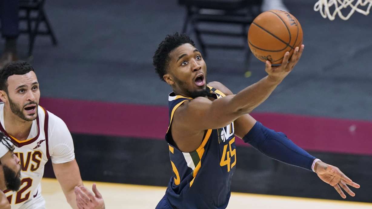 Utah Jazz's Donovan Mitchell (45) drives to the basket as Cleveland Cavaliers' Larry Nance Jr. watches during the first half of an NBA basketball game Tuesday, Jan. 12, 2021, in Cleveland. (AP Photo/Tony Dejak)