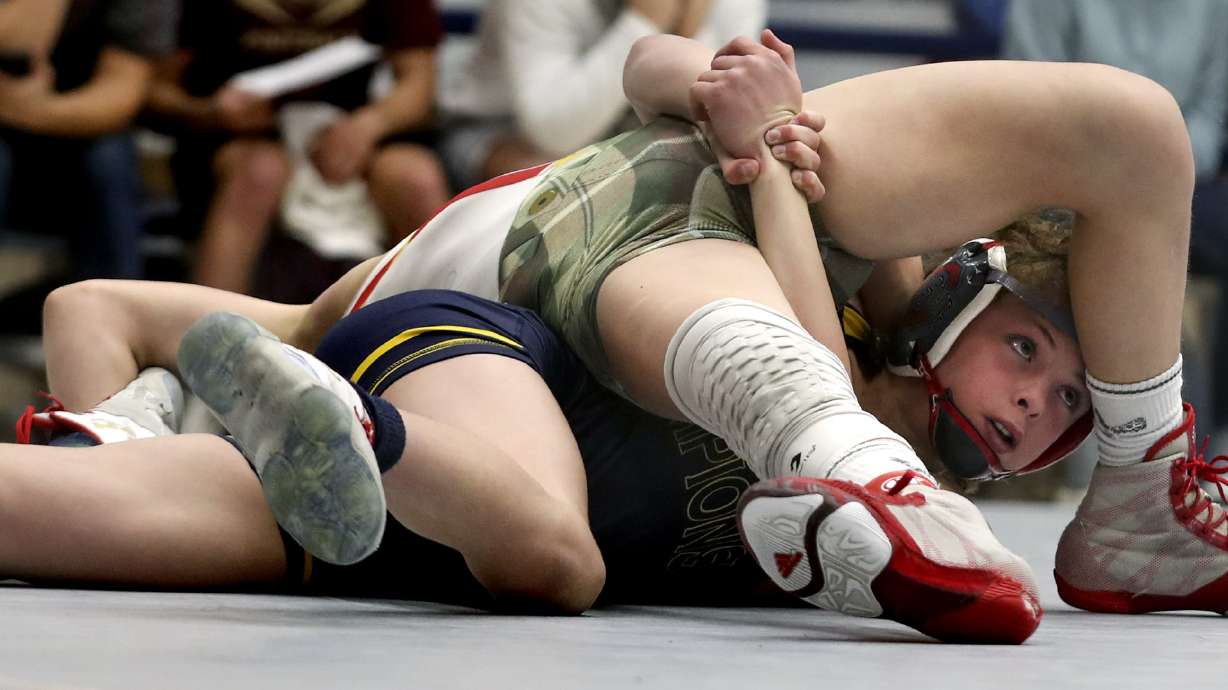 Austin Paris, right, looks to the clock as he holds Dillon Ivie during their 102-pound junior high school match in the Utah All-Star Duals event at Telos Gymnasium in Orem on Tuesday, Jan. 12, 2021.