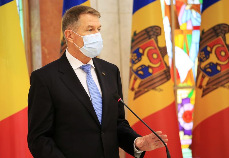 FILE PHOTO: Romania's President Klaus Iohannis attends a joint news conference with Moldova's President Maia Sandu following a meeting in Chisinau, Moldova December 29, 2020. REUTERS/Vladislav Culiomza