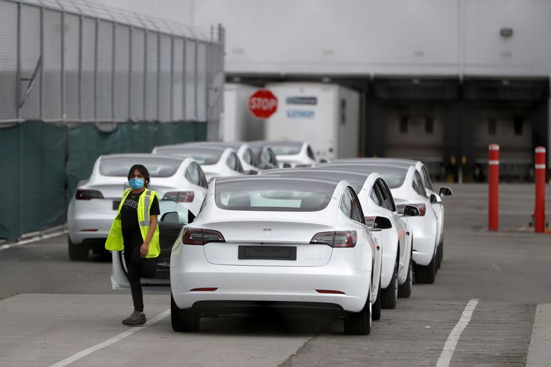 FILE PHOTO: A worker exits a Tesla Model 3 electric vehicle at Tesla's primary vehicle factory after CEO Elon Musk announced he was defying local officials' coronavirus disease (COVID-19) restrictions by reopening the plant in Fremont, California, U.S. May 11, 2020. REUTERS/Stephen Lam