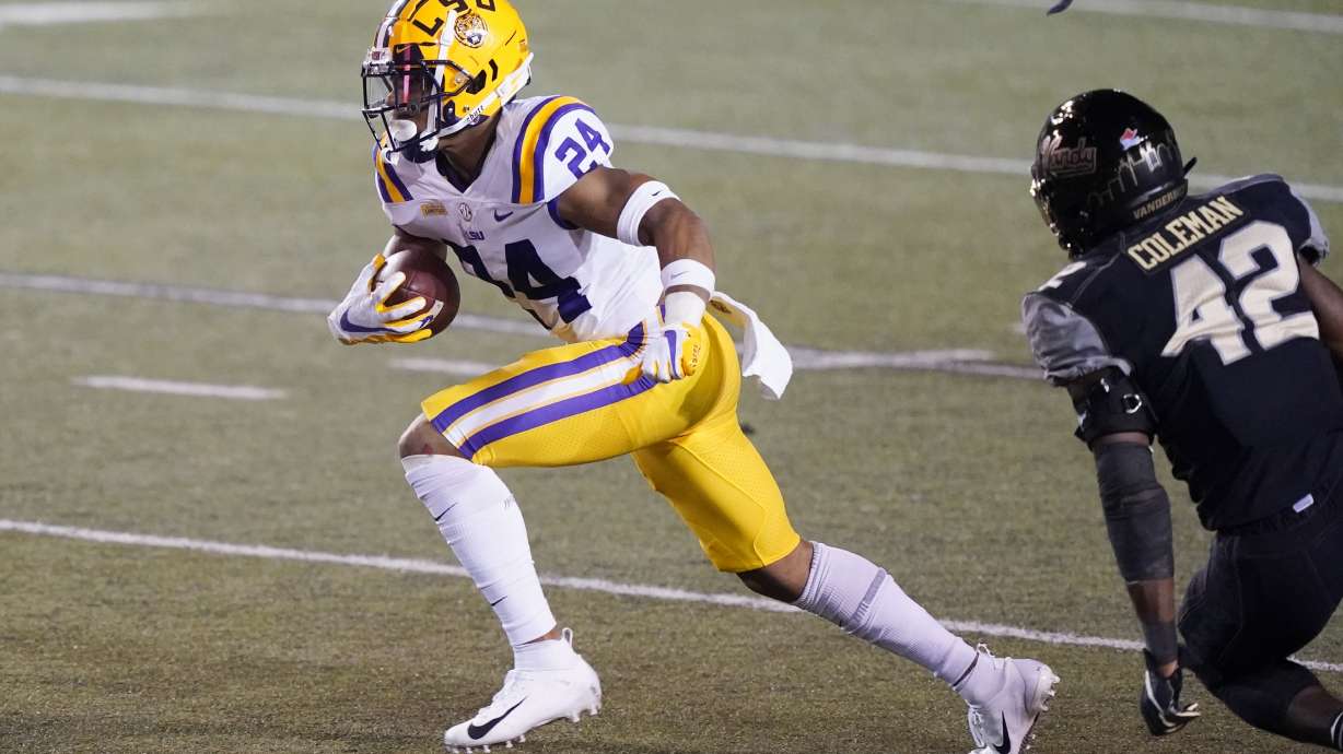 LSU running back Chris Curry (24) gets past Vanderbilt defensive back Camden Coleman (42) in the second half of an NCAA college football game Saturday, Oct. 3, 2020, in Nashville, Tenn. LSU won 41-7. (AP Photo/Mark Humphrey)