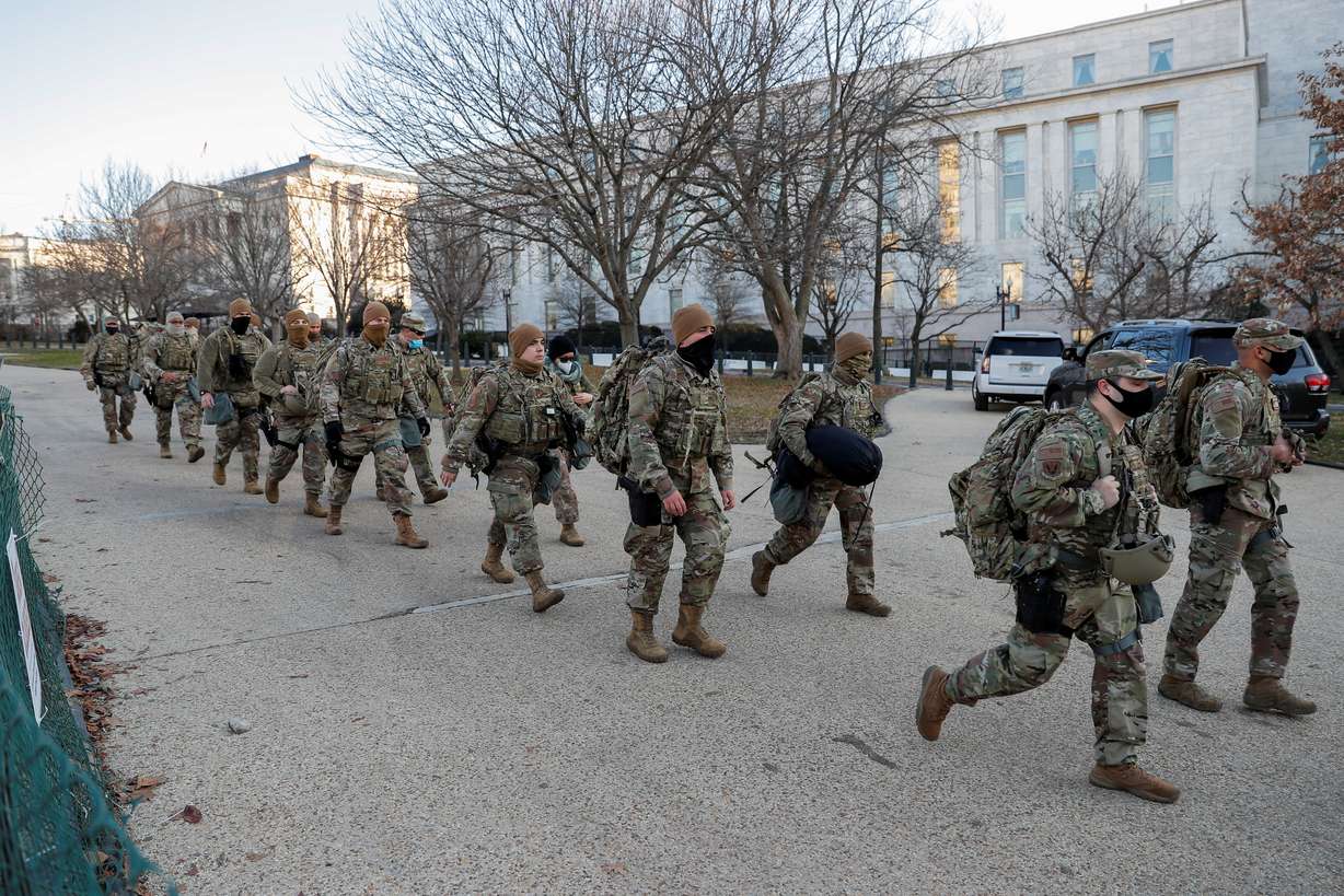U.S. National Guard members walk near the U.S. Capitol Building on Capitol Hill in Washington, U.S., January 13, 2021.