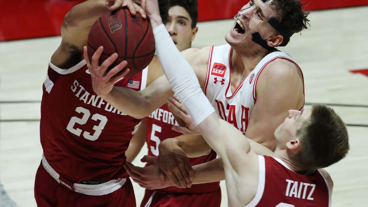 Utah Utes forward Mikael Jantunen (20) drives on Stanford Cardinal forward Brandon Angel (23) in Salt Lake City on Thursday, Jan. 14, 2021. The Utes won 79-65.