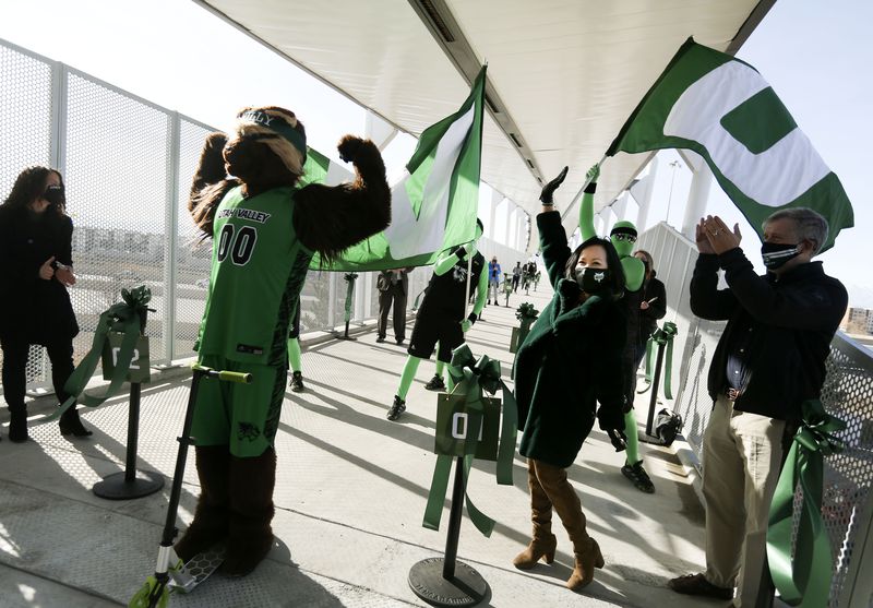 Utah Valley University mascot Willy the Wolverine,
left, President Astrid Tuminez and others celebrate the opening of
the new pedestrian bridge connecting UVU with the Utah Transit
Authority’s FrontRunner Orem Central Station on Thursday, Jan.14,
2021.